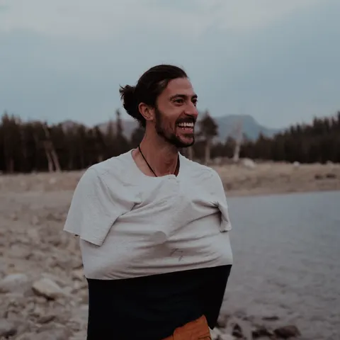 Miguel Casar laughing on a lakeshore.